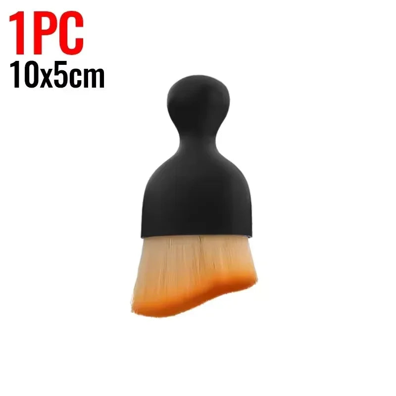 A black multi-surface cleaning brush with a yellow-orange bristles shown against a white background.