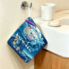 A blue and white Totoro cartoon-themed hanging hand wiping towel is displayed on a wall.