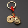 Vintage gold-tone lucky cat keychain with a red tassel and gold-toned circular charm