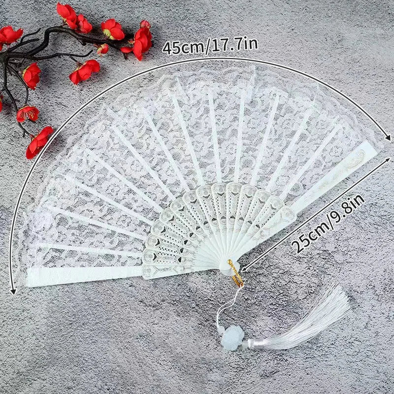 White lace fabric folding hand fan with red accents shown open and closed.