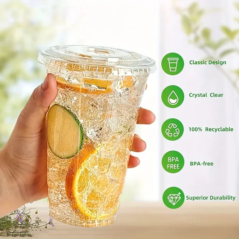 A hand holds a clear reusable plastic cup with a lid filled with orange slices and water.