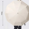 A beige automatic folding umbrella with a dome shape is shown, viewed from the side.