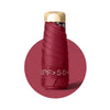 A compact folding UV protection umbrella with a gold-colored handle and a deep red fabric cover.