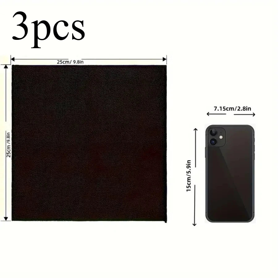 Three black reusable microfiber cleaning cloths shown next to a smartphone for scale.