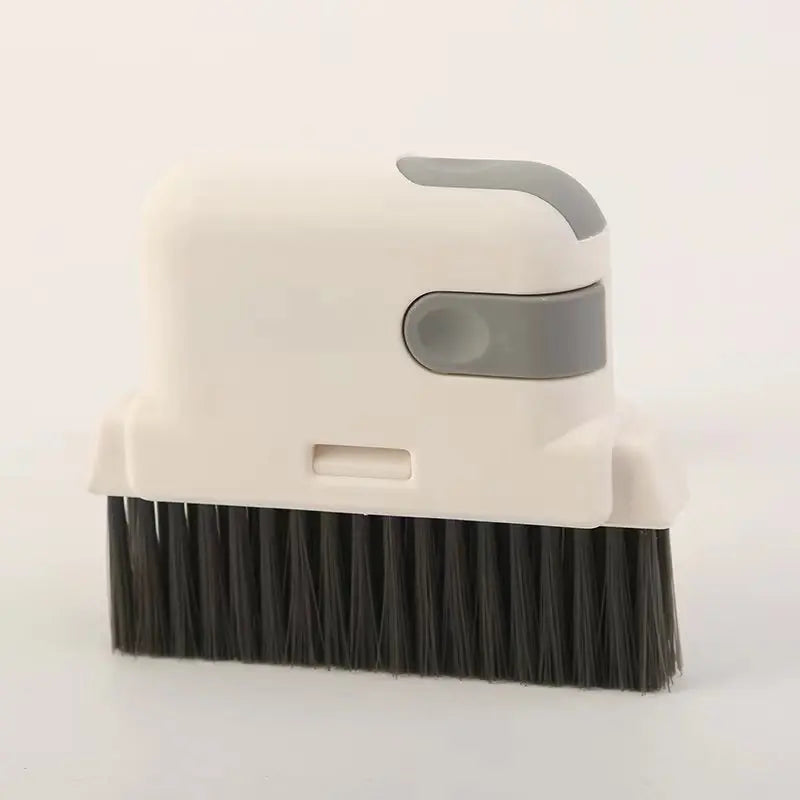 Cepillo universal para limpiar ventanas y rieles blanco con mango y cerdas grises.
