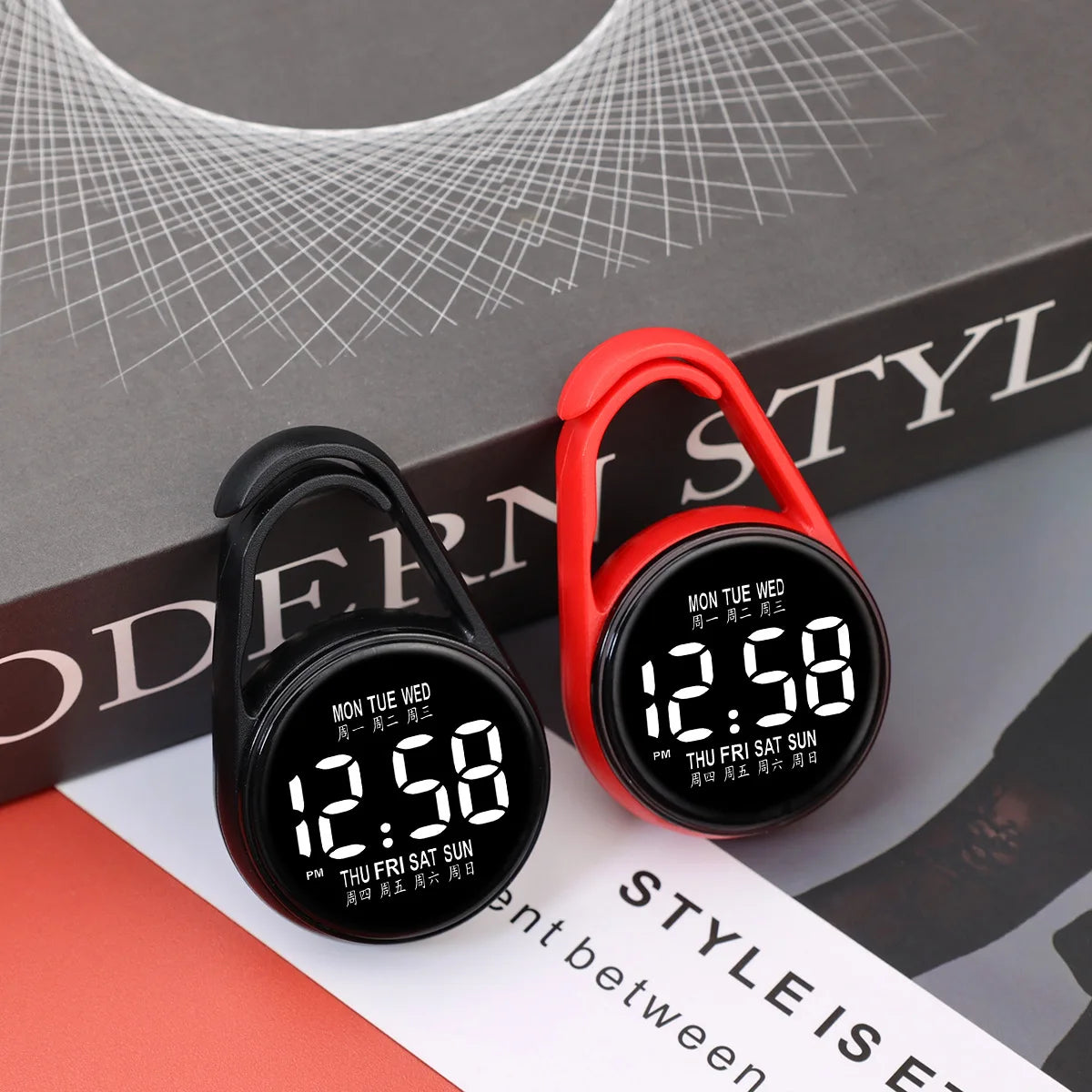 A pair of red and black digital LED hanging pocket watches displayed on a gray background.
