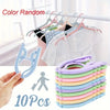 A set of 10 purple and green portable foldable clothes hangers shown next to a hand and a white wooden rack.
