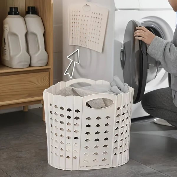 A white folding hand-held clothes storage basket is shown next to a washing machine and laundry detergent bottles.