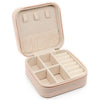 A light beige portable PU leather jewelry storage box with a hinged lid and divided compartments.