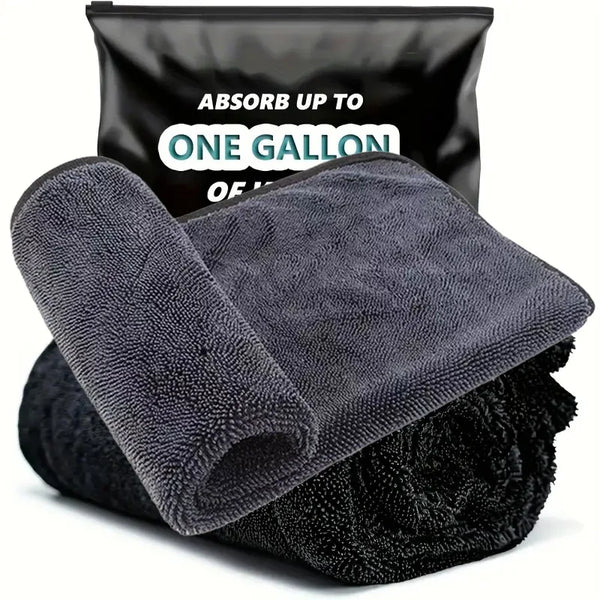 A black microfiber car cleaning towel is shown next to a black storage bag.