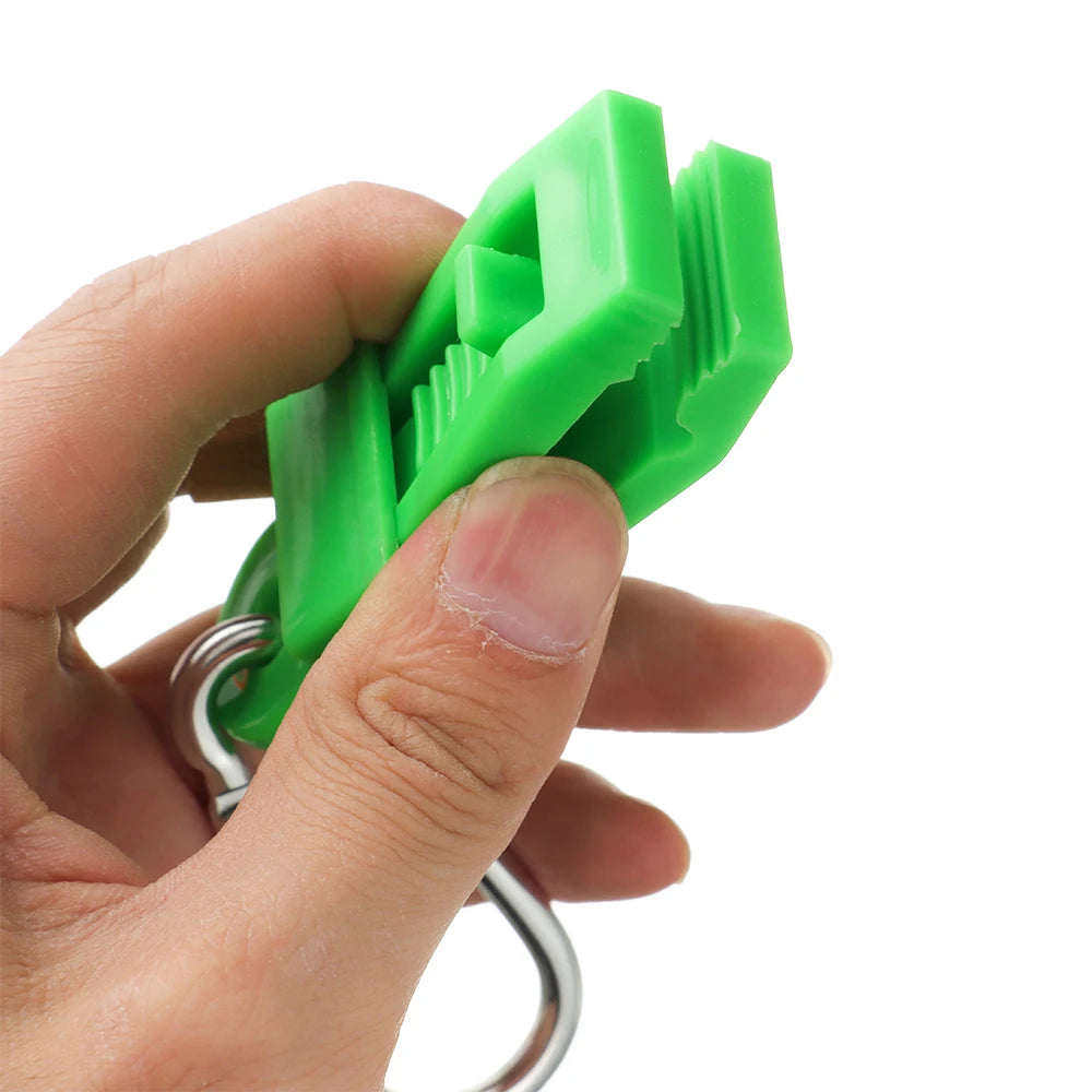A hand is holding a bright green durable glove clip with an ergonomic buckle for work safety.