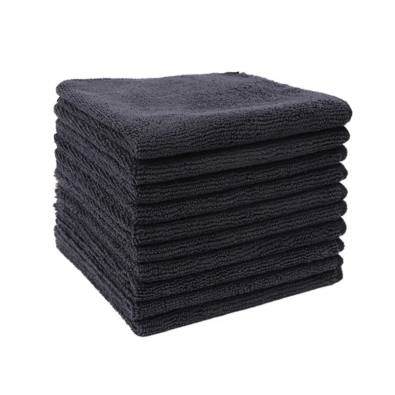 A stack of ten dark gray reusable microfiber cleaning cloths.