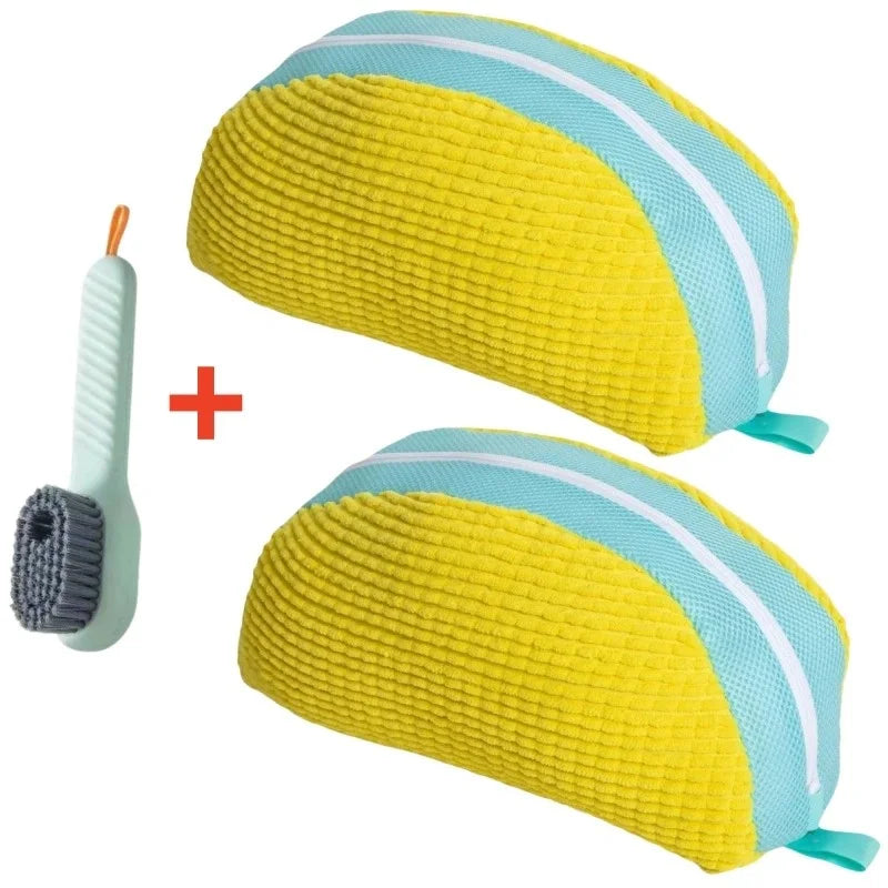 A yellow and light blue fabric storage bag for shoes, shown next to a cleaning brush.