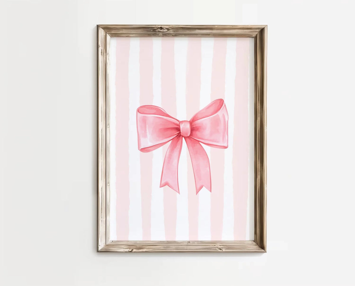 Pink striped canvas wall art featuring a pink bow design in a light wood frame.