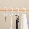 White space-saving rotating closet organizer hooks hanging from a wooden rod