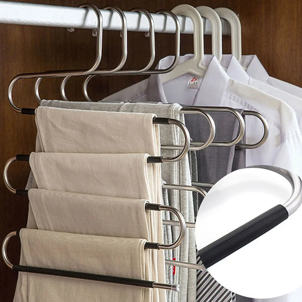 Stainless steel S-shaped storage rack holding folded towels and pants on a hanger