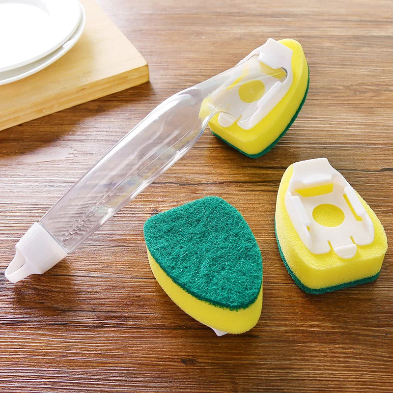 A dish wand cleaning brush set featuring a yellow and green sponge with a clear handle on a wooden surface.