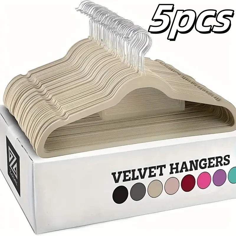 A box containing five velvet hangers with a light beige color and a clear plastic hanger display.