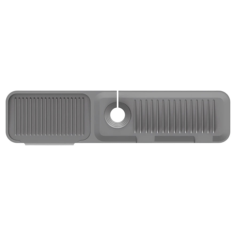 A gray silicone sink splash guard mat with vertical ridges and a circular drain hole.
