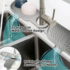 A silicone sink splash guard and drip catcher mat with a large water outlet design shown in a kitchen sink.