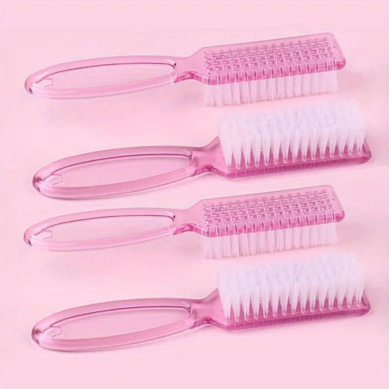 A set of four pink plastic brushes, including spatulas and various bristles for nail art and dust cleaning.
