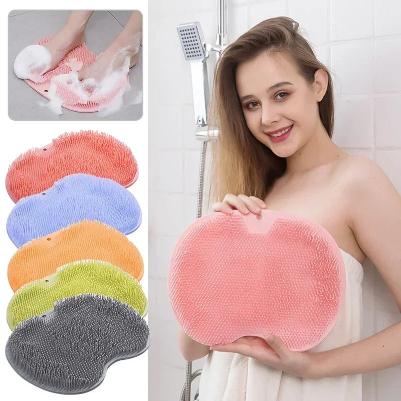 A woman holds a pink reusable silicone foot scrub brush, showing its texture and shape.