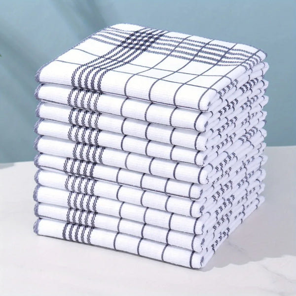 A stack of six white and gray absorbent dish cloths folded neatly on a white surface.