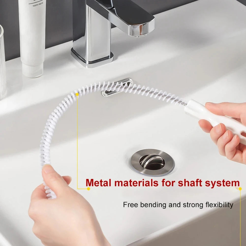 A hand is holding a flexible metal brush with a coiled shaft, demonstrating its free bending and strong flexibility for drain