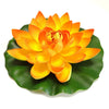 An artificial orange lotus flower blooming on a green leaf.