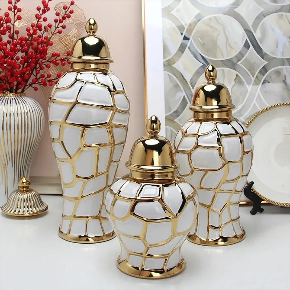 Three decorative ceramic flower vases with gold accents and white textured bodies.
