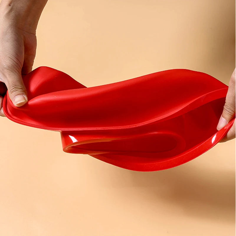 A hand is holding a bright red silicone number cake mold, showing its flexible and contoured shape.