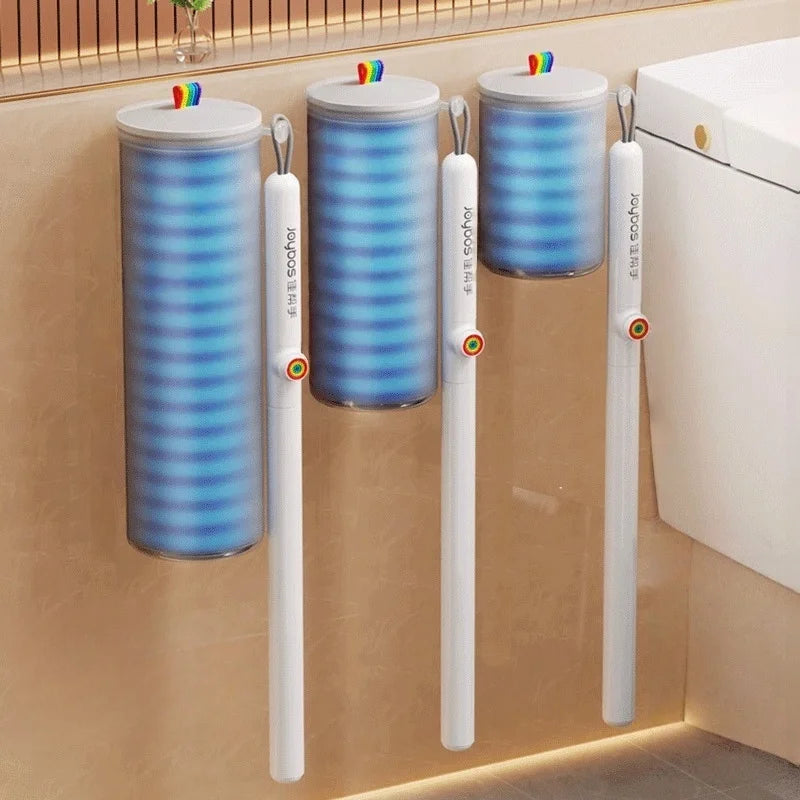A set of disposable toilet brush cleaning kits with blue and purple striped handles and colorful brush heads mounted on a wal