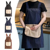 A woman wearing a dark blue striped sleeveless kitchen apron with a removable beige hand towel.