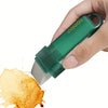 A hand holds a green reusable household stain remover eraser, applying it to a stained surface.