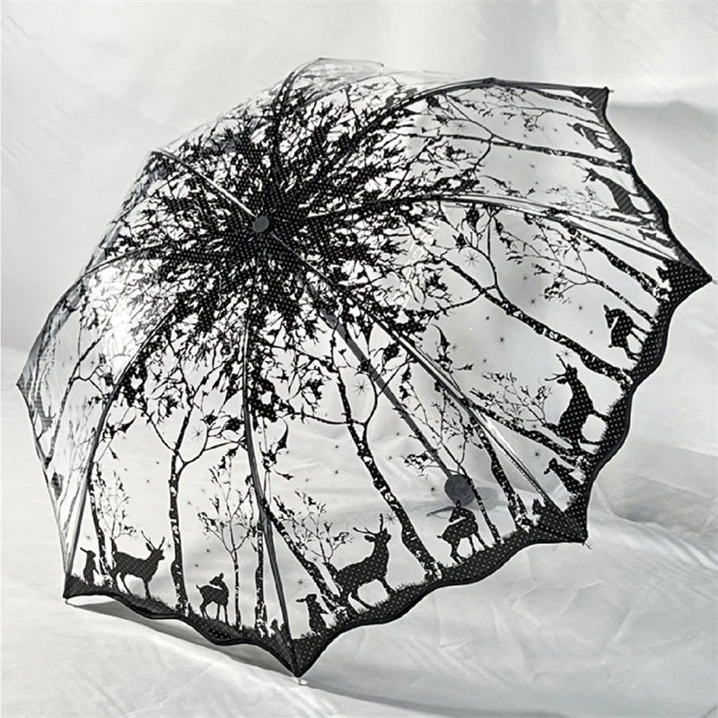 A retro transparent folding umbrella featuring a silhouette pattern of deer and woodland trees.