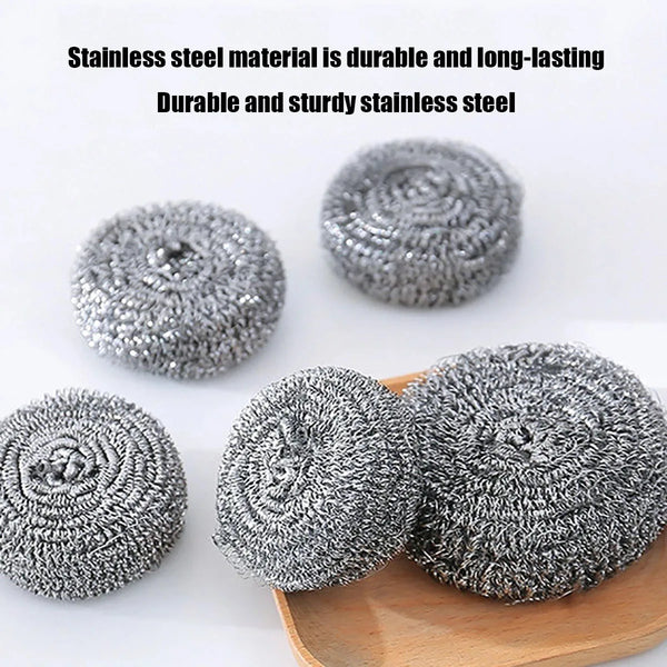 A pile of durable and sturdy grey stainless steel scrubber pads on a wooden surface.