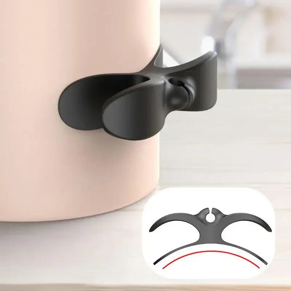 A black reusable cable management organizer clip is shown against a light background.