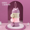 A stack of three purple and pink silicone snack containers for toddlers displayed on a round white marble stand.