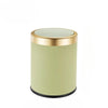 A cylindrical trash can with a light green ribbed body and a gold rim and lid.