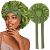A woman wearing a satin green sleeping cap with an adjustable tie band and gold earrings.