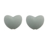 A pair of smooth, heart-shaped silicone charm beads in a light gray color.