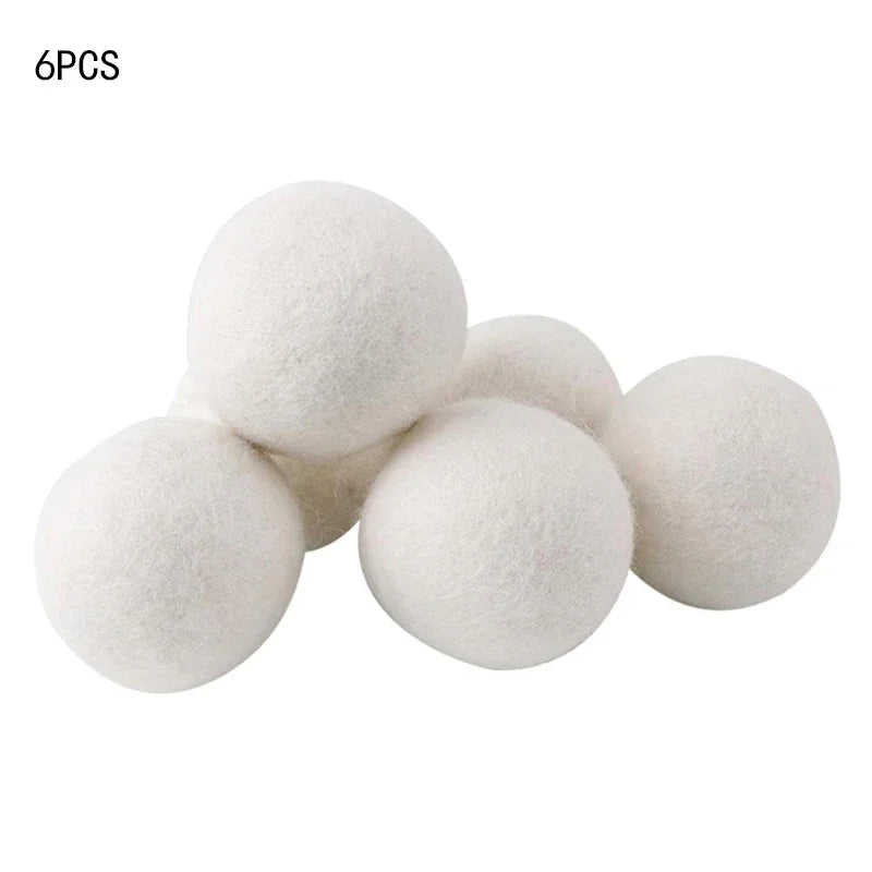 Six white reusable wool dryer balls for clothes drying