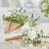 A floral arrangement featuring white roses and baby's breath flowers on sheer fabric.