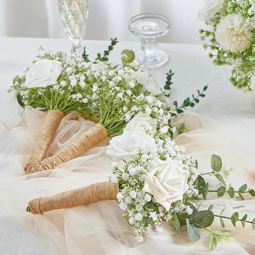 A floral arrangement featuring white roses and baby's breath flowers on sheer fabric.