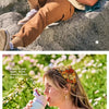 A woman drinks directly from an Owala insulated stainless steel water bottle with a straw outdoors.