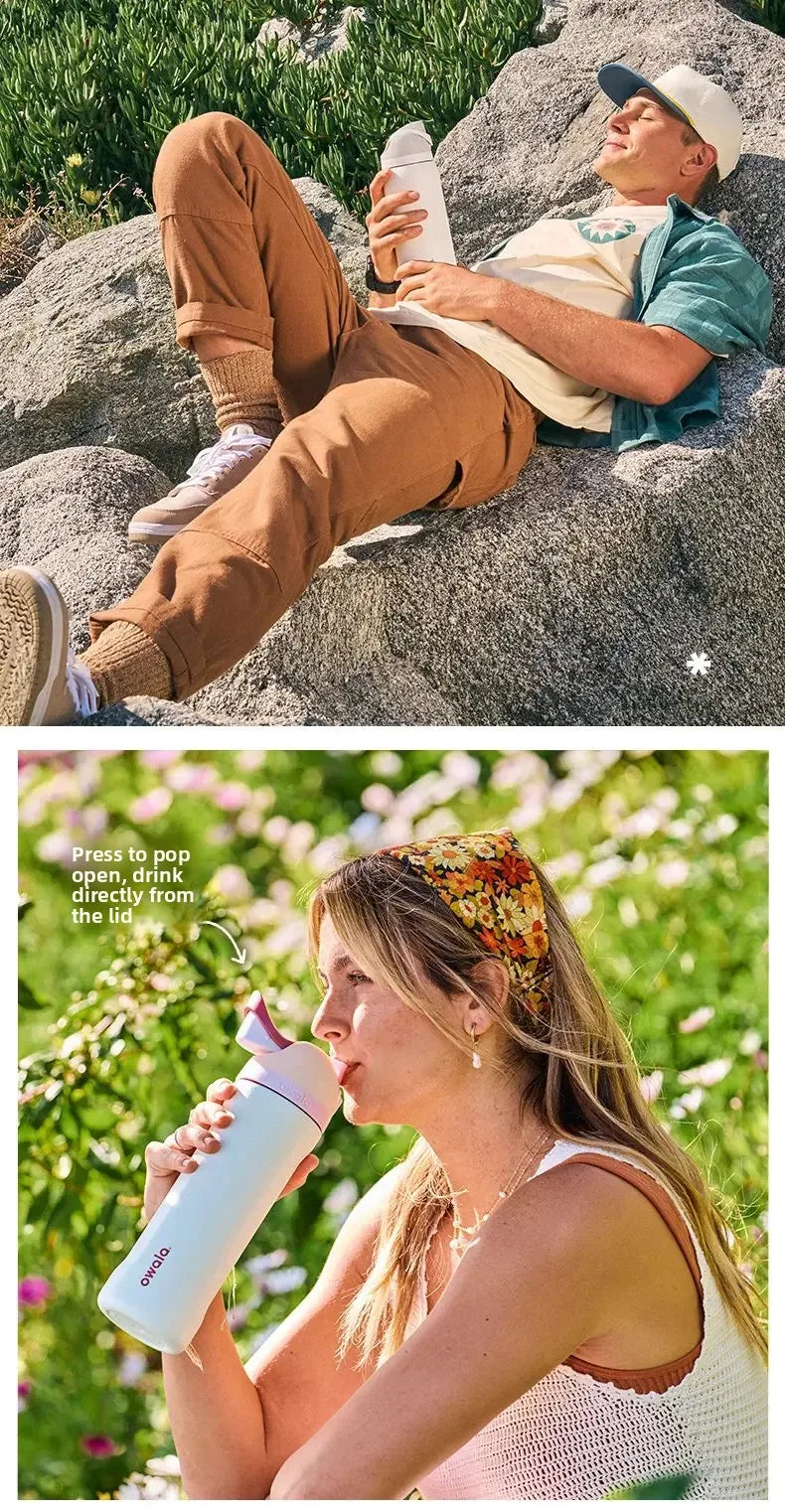 A woman drinks directly from an Owala insulated stainless steel water bottle with a straw outdoors.