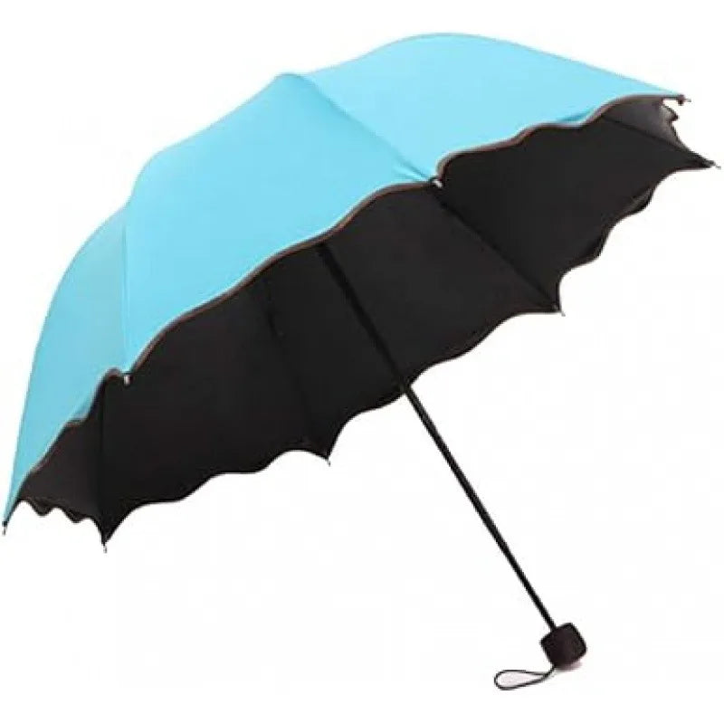 A light blue and black reversible umbrella open, showing its canopy and handle.