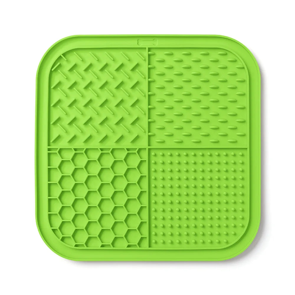 A bright lime green silicone lick mat designed for dogs and cats with various textured surfaces.
