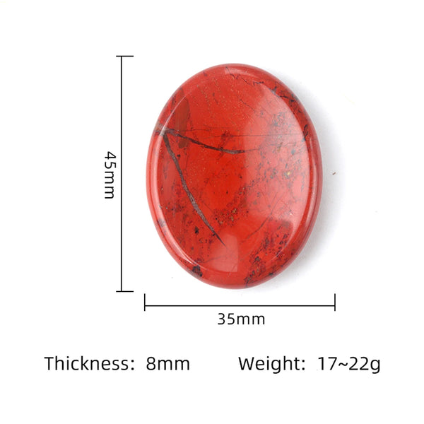 A smooth, oval, reddish-orange natural quartz thumb stone with visible dark veining.