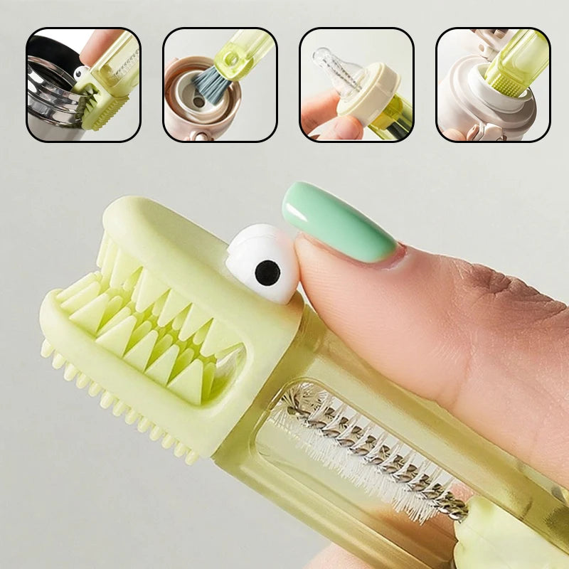 A hand holds a light green silicone cleaning brush set with multiple attachments, including a toothbrush and a small cleaning